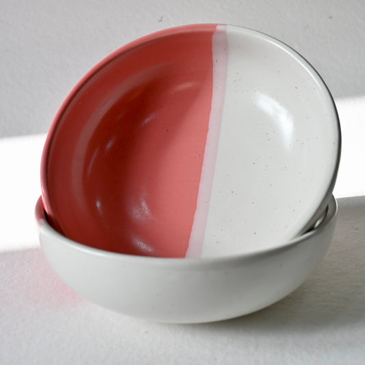 Two ceramic bowls with a red and white design on a light gray background from Saabi House
