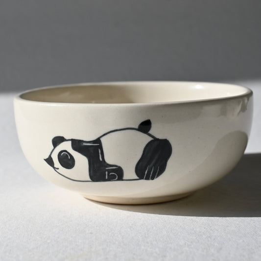 Ceramic bowl with a panda design on a gray background
