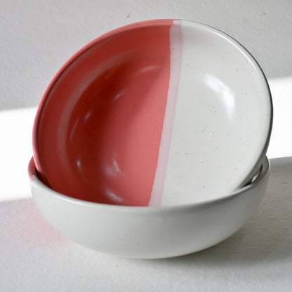 Two ceramic bowls with a red and white design on a light gray background  from Saabi House 