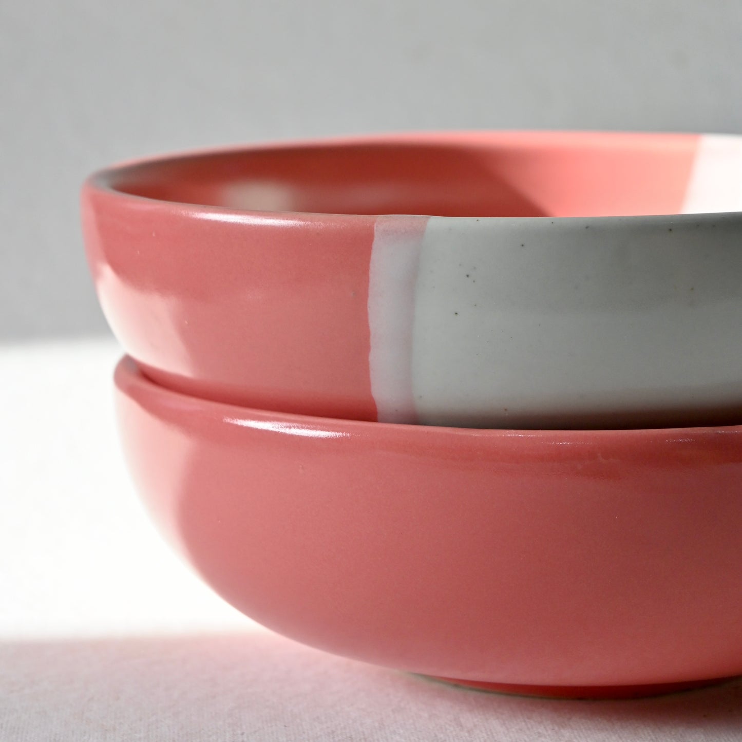 Two pink ceramic bowls stacked on a light gray background  from Saabi House 