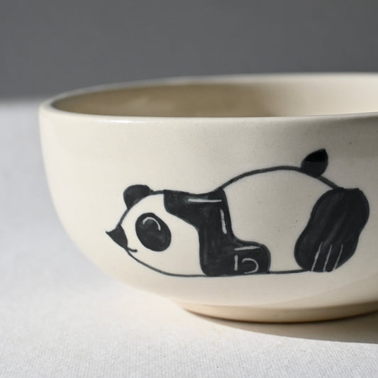 Ceramic bowl with a panda design on a white surface from Saabi House