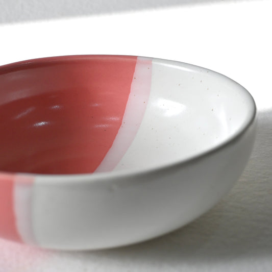 White ceramic bowl with a pink interior on a white background from Saabi House 