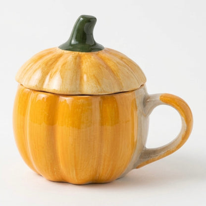 Pumpkin-shaped mug with a lid on a white background