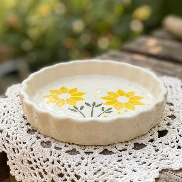 Ceramic dish with yellow floral design on a lace doily